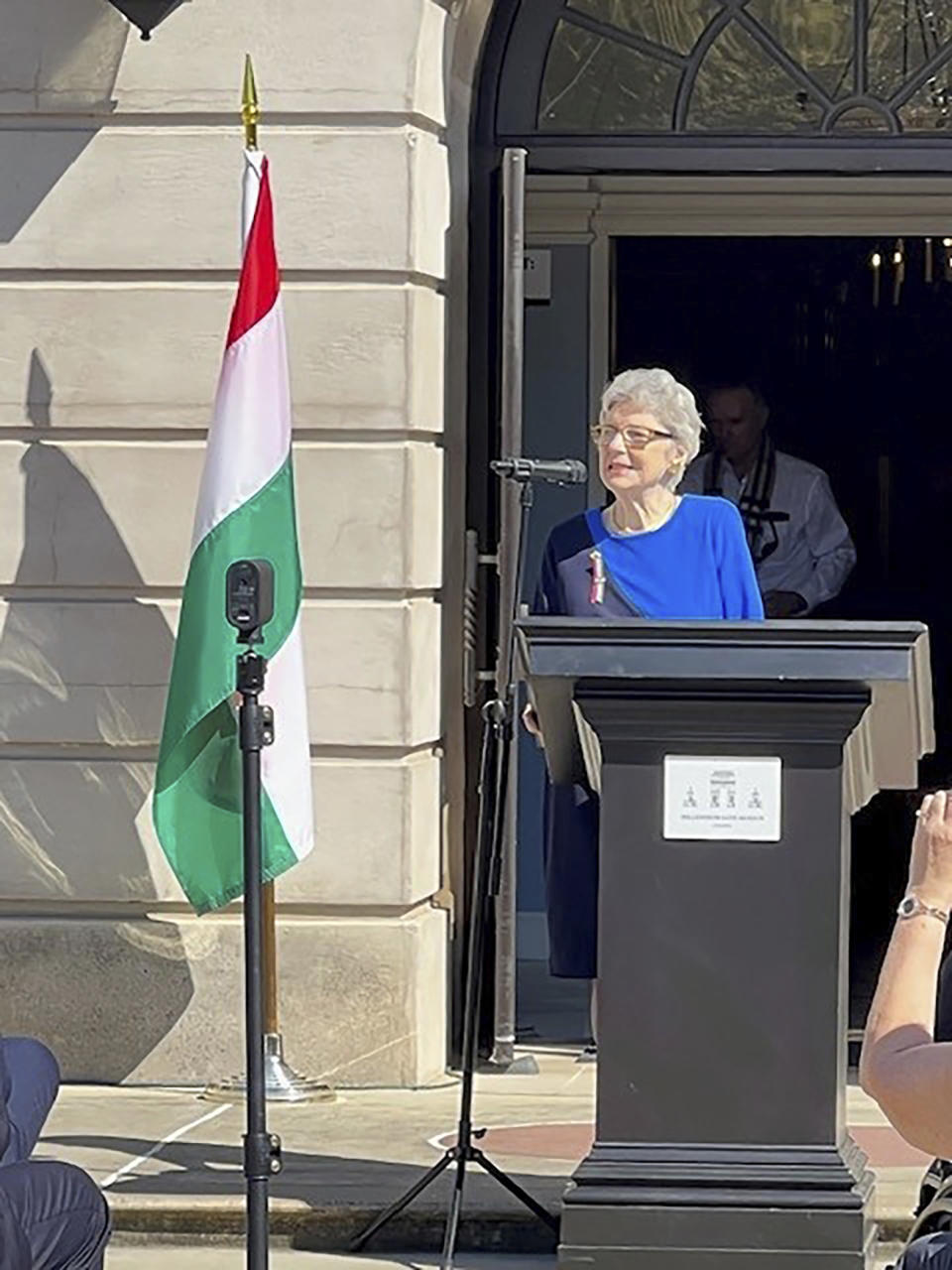 Edith Lauer poses outside the Millennium Gate Museum in Atlanta, Georgia, in October 2022 at the unveiling of the 1956 Hungarian Freedom Fighter Statue. Lauer, 81, was a 14-year-old student when she left Budapest, Hungary, with her parents in 1956 . They were paroled in the United States. (Kriszta Lauer Nagy via AP)