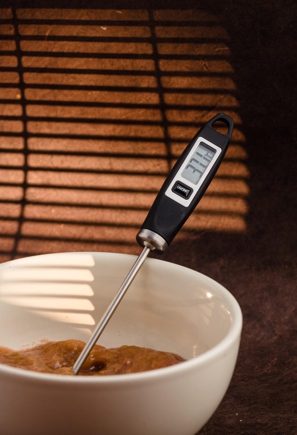 A cooking thermometer in a bowl of food