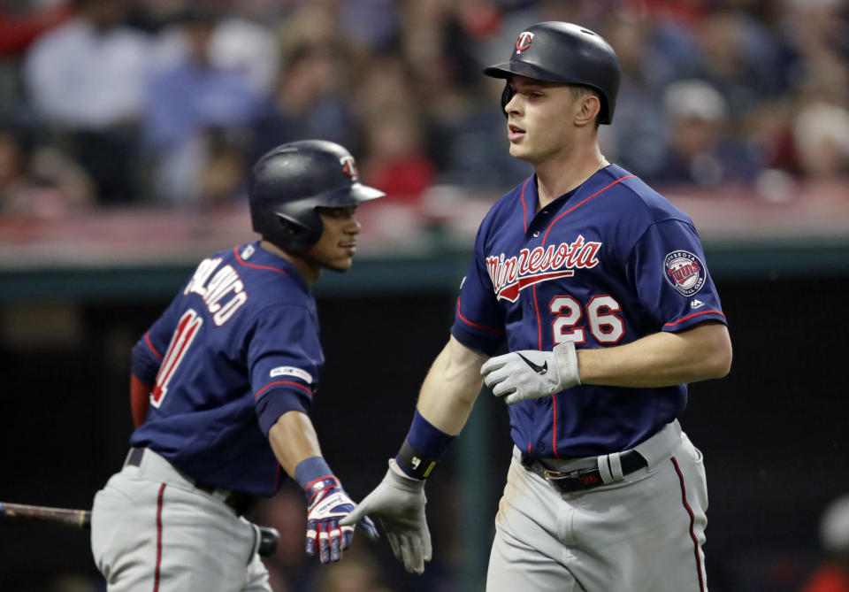Minnesota Twins' Max Kepler, right, is congratulated by Jorge Polanco after Kepler hit a solo home run during the seventh inning of the team's baseball game against the Cleveland Indians, Thursday, June 6, 2019, in Cleveland. (AP Photo/Tony Dejak)