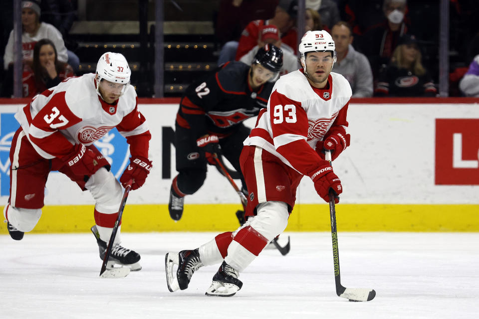 Detroit Red Wings' Alex DeBrincat (93) moves the puck upice against the Carolina Hurricanes during the first period of an NHL hockey game in Raleigh, N.C., Friday, Jan. 19, 2024. (AP Photo/Karl B DeBlaker)