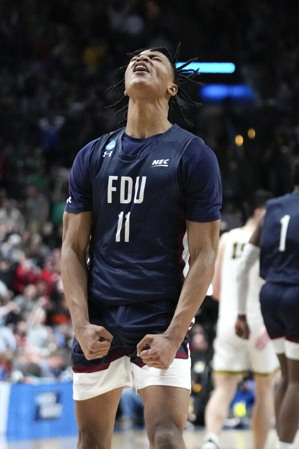 Fairleigh Dickinson forward Sean Moore (11) reacts after a basket against Purdue in the second half of a first-round college basketball game in the NCAA Tournament Friday, March 17, 2023, in Columbus, Ohio. (AP Photo/Paul Sancya)