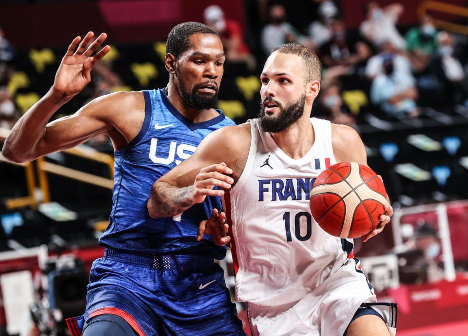 Evan Fournier of France drives to the basket as Kevin Durant of USA guards him.