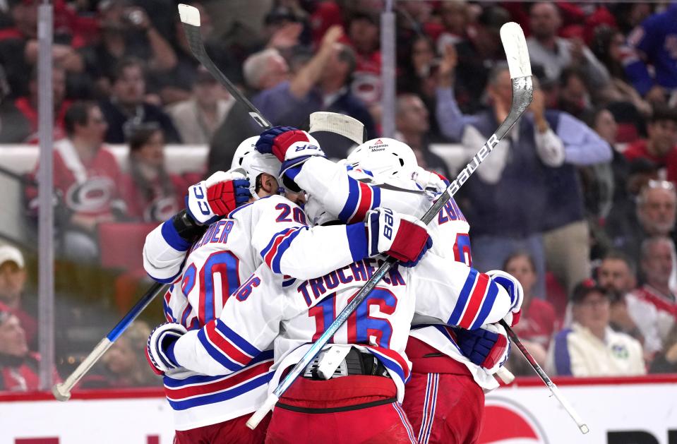 RALEIGH, NORTH CAROLINA - MAY 16: Chris Kreider #20 of the New York Rangers is congratulated by teammates after scoring a goal against the Carolina Hurricanes during the third period in Game Six of the Second Round of the 2024 Stanley Cup Playoffs at PNC Arena on May 16, 2024 in Raleigh, North Carolina.