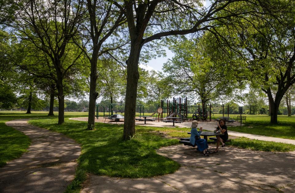 Susan Stellar, left, sits on a bench as she talks with Gail Tubbs during an event at Rouge Park in Detroit on Wednesday, May 22, 2024. Detroit Parks Coalition announced the kickoff of new family-friendly programs and activities across multiple city parks in Detroit.