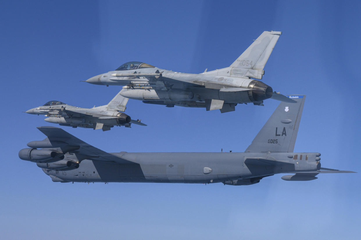 In this photo provided by South Korea Defense Ministry, a U.S. Air Force B-52H Stratofortress aircraft, bottom, flies in formation with South Korea's Air Force KF-16 fighters over the western sea of Korean peninsula during a joint air drill in South Korea, Monday, March 6, 2023.(South Korea Defense Ministry via AP)