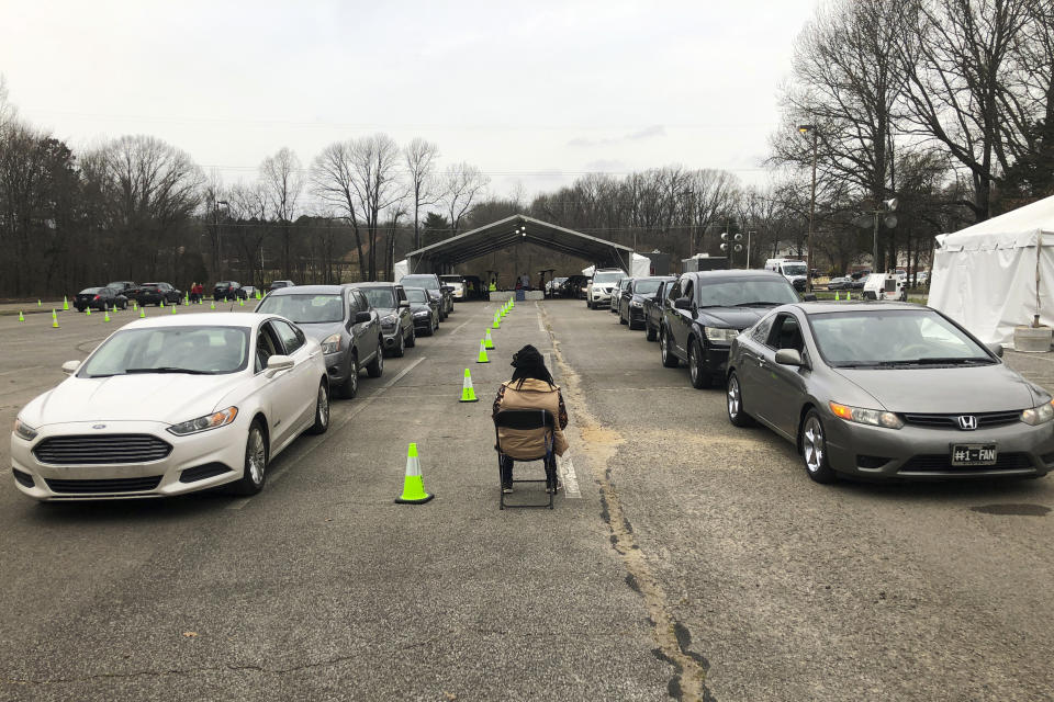 People sitting in two lines of cars wait to get a COVID-19 vaccination Friday, March 12, 2021, in Memphis, Tenn. As millions continue to wait their turn for the COVID-19 vaccine, small but steady amounts of the precious doses have gone to waste across the country. It's a heartbreaking reality that experts acknowledged was always likely to occur. (AP Photo/Adrian Sainz)