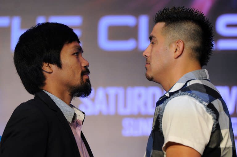 Philippine boxing icon Manny Pacquiao (L) and Brendon Rios of the US go face-to-face during a pre-fight press conference in Macau on July 27, 2013. Pacquiao insists he is as fit as ever and has ignored calls from friends, family and media commentators, fearful for his health, to call it a day