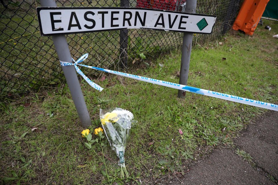 Flowers lay next to a police line cordon at the scene where bodies were discovered in a lorry container, in Grays, Essex, Britain October 23, 2019.  REUTERS/Hannah McKay