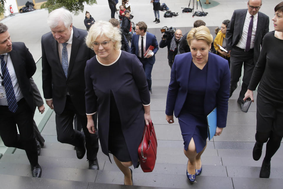 German Interior Minister Horst Seehofer, center left, German Justice Minister Christine Lambrecht, center, and German Minister for Family Affairs, Senior Citizens, Women and Youth, Franziska Giffey, center right, arrive for a news conference in Berlin, Germany, Wednesday, Oct. 30, 2019 on a package of measures against far-right extremism and anti-Semitism. Chancellor Angela Merkel's Cabinet signed off Wednesday on the tightening of gun laws, stricter persecution of hate crime online, and more financial support for initiatives fighting anti-Semitism and far-right extremism. (AP Photo/Markus Schreiber)