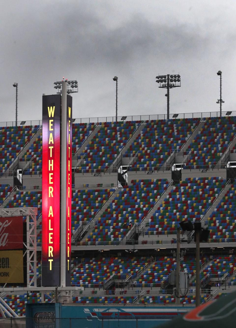 A new LED scoring pylon at Daytona International Speedway flashes a weather alert Saturday as heavy rain moves over the area before the scheduled time for the Coke Zero Sugar 400.