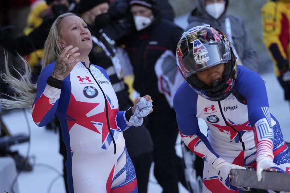 Kaillie Humphries, left, and Sylvia Hoffmann of the United States react after the women's two-women bobsleigh World Cup race in Igls, near Innsbruck, Austria, Sunday, Nov. 21, 2021. (AP Photo/Matthias Schrader)