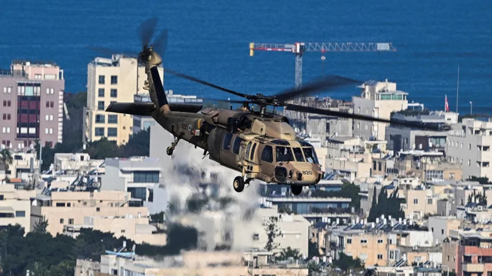 PHOTO: An Israeli military helicopter flies over Tel Aviv, amid the ongoing conflict in Gaza between Israel and Hamas, in Tel Aviv, Israel, Feb. 20, 2024.  (Dylan Martinez/Reuters)