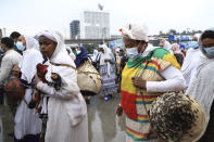 Women bring items to give to the youth joining the Defense Forces, at Meskel Square, in Addis Ababa, Ethiopia, Tuesday, July 27 2021. A repatriation program is underway for young people from Ethiopia who have decided to join the Defense Forces. (AP Photo)