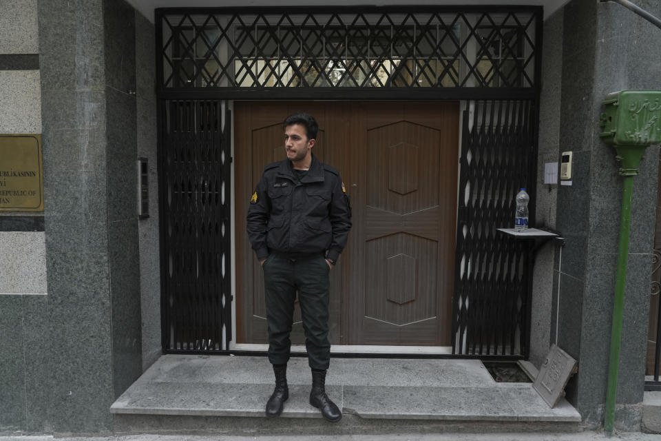 A police officer stands in front of the Azerbaijan Embassy in Tehran, Iran, Friday, Jan. 27, 2023. A man armed with a Kalashnikov-style rifle stormed the Azerbaijan Embassy in Iran's capital Friday, killing the head of security at the diplomatic post and wounding two guards, authorities said. (AP Photo/Vahid Salemi)