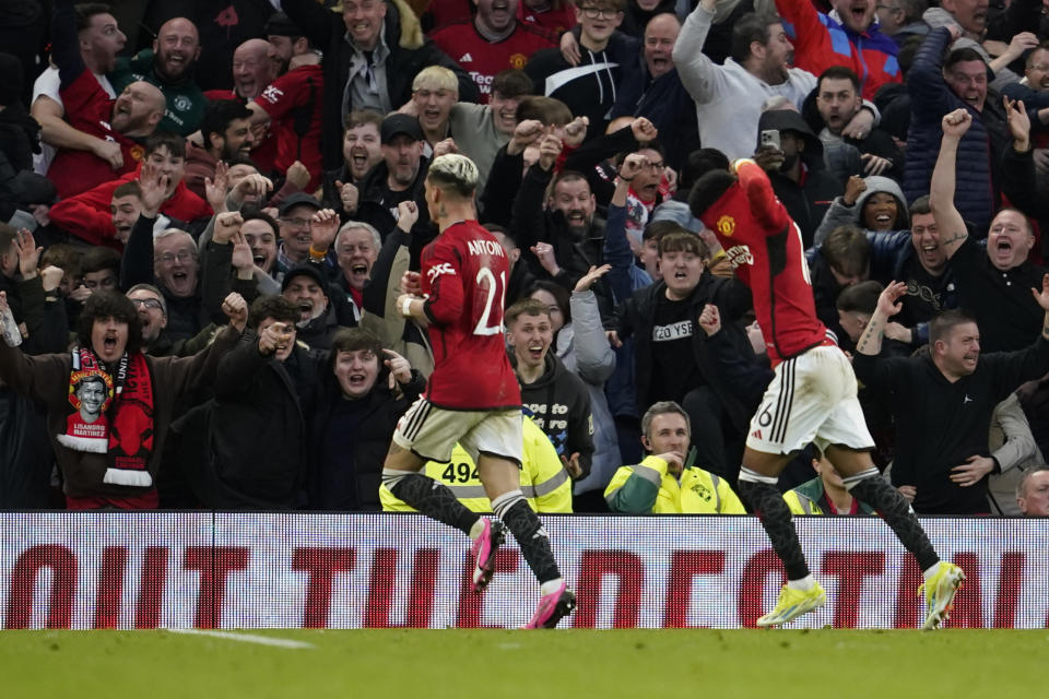 Manchester United's Amad Diallo, right, celebrates after scoring his side's fourth goal during the FA Cup quarterfinal soccer match between Manchester United and Liverpool at the Old Trafford stadium in Manchester, England, Sunday, March 17, 2024. (AP Photo/Dave Thompson)