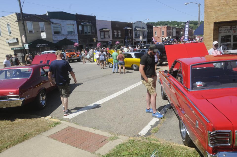 Spectators look at cars during the Loudonville Car Show held Saturday July 2 in downtown Loudonville.