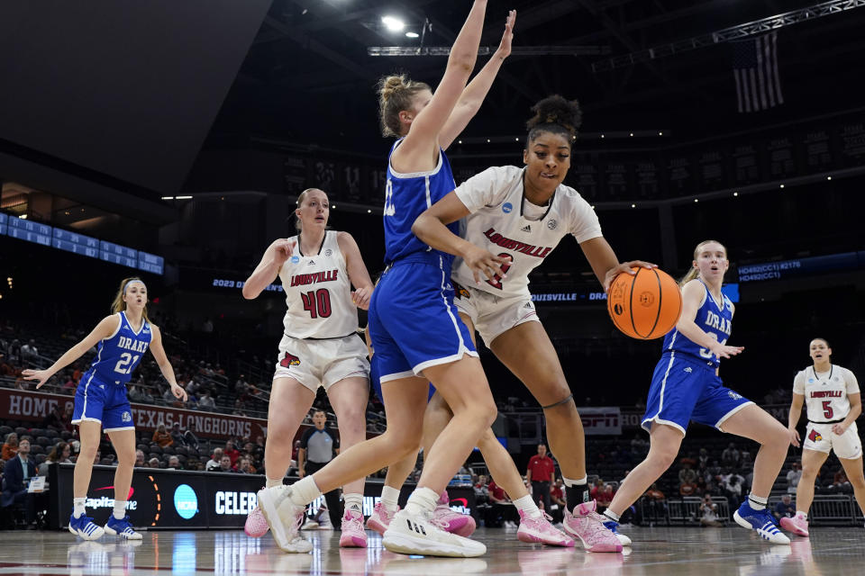 FILE - Louisville forward Nyla Harris (2) is pressured by Drake forward Maggie Bair (42) during the first half of a first-round college basketball game in the NCAA Tournament in Austin, Texas, Saturday, March 18, 2023. Despite this summer’s successful performance, Louisviile coach Jeff Walz cautions that cohesion is a work in progress as the new faces blend with seniors Olivia Cochran (8.4 points, 6.5 rebounds per game) and Merissah Russell and sophomores Nyla Harris and Alexia Mobley for the grind. (AP Photo/Eric Gay, File)