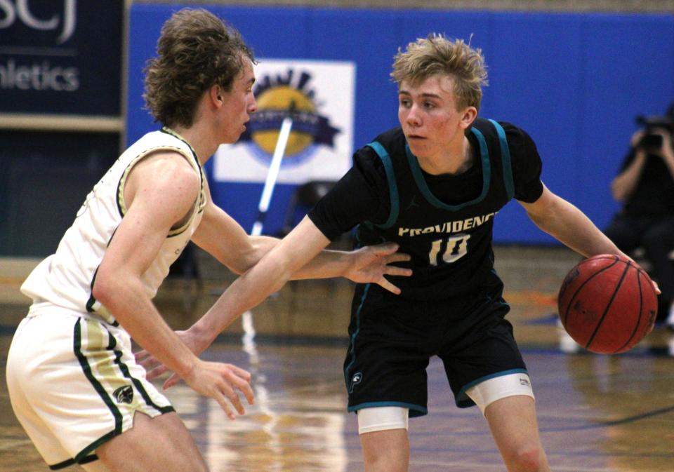 Providence guard Caleb McAbee (10) dribbles as Nease's Jake Larson (5) defends  during the High School 9:12 Fortegra Invitational for boys basketball at FSCJ South Campus on December 10, 2022. [Clayton Freeman/Florida Times-Union]