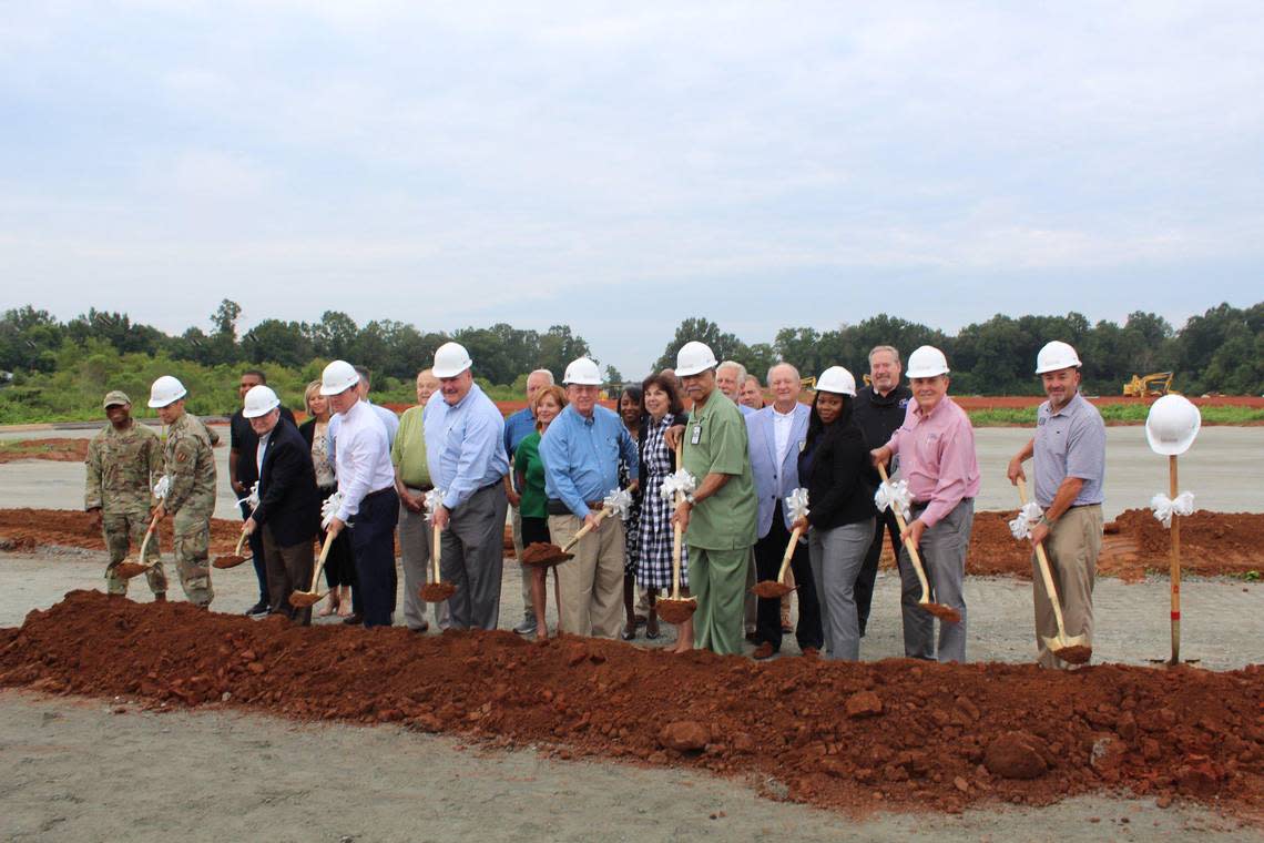 Officials from the Houston County Board of Commissioners, Houston County Board of Education and the city governments of Warner Robins, Perry and Centerville break ground at the construction site.