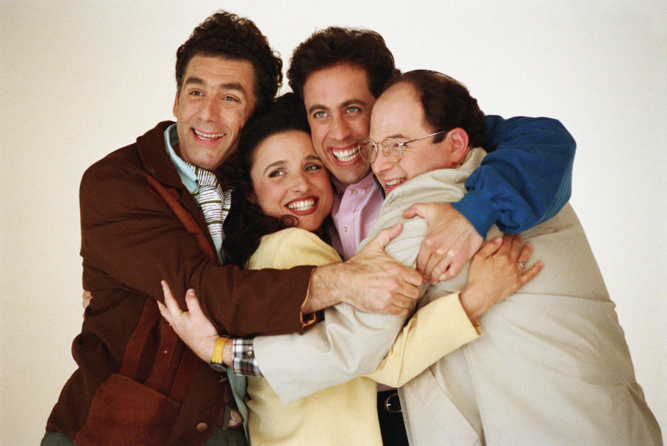 Michael Richards, Julia Louis-Dreyfus, Jerry Seinfeld and Jason Alexander embracing in 1993
