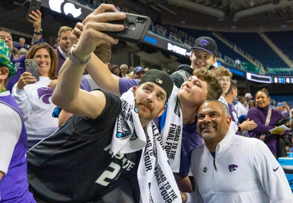 Kansas State coach Jerome Tang takes photos with Wildcat fans after picking up his first NCAA Tournament victory as a head coach after defeating Montana State in Greensboro, NC on Friday night.