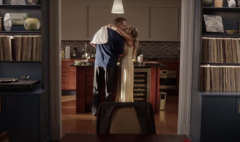 Big and Carrie kiss in the middle of their kitchen