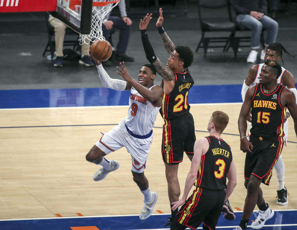 New York Knicks guard RJ Barrett (9) drives for a layup against Atlanta Hawks forward John Collins (20) during the third quarter of an NBA basketball game Wednesday, April 21, 2021, in New York. (Wendell Cruz/Pool Photo via AP)