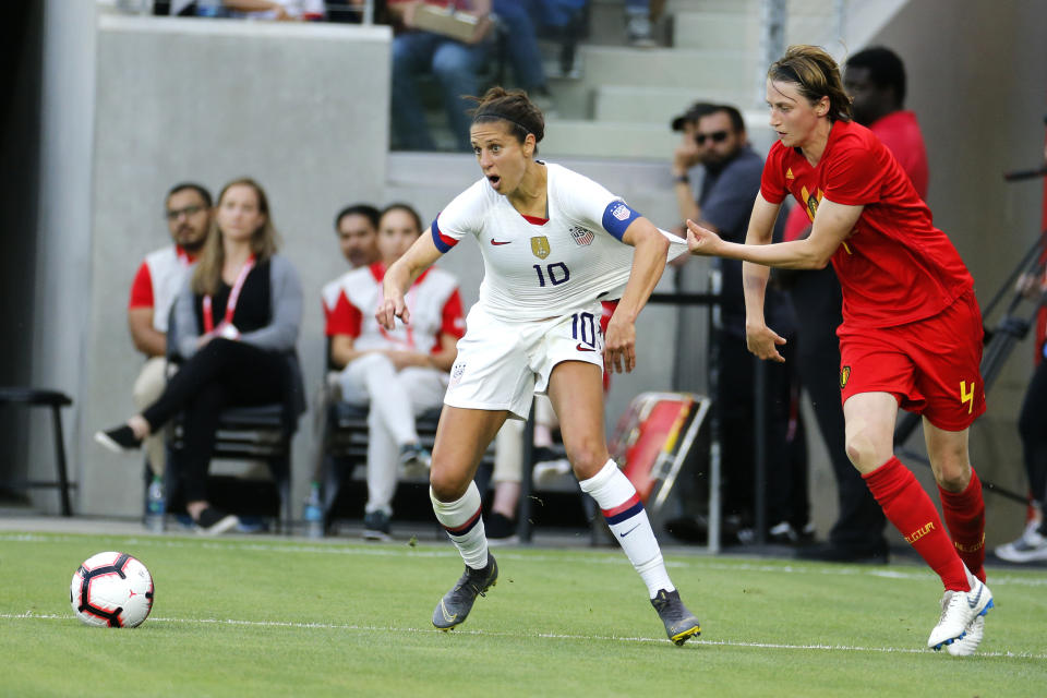 Belgium defender Heleen Jaques (4) grabs United States forward Carli Lloyd (10) during the first half of their international friendly soccer match Sunday, April 7, 2019, in Los Angeles. (AP Photo/Ringo H.W. Chiu)