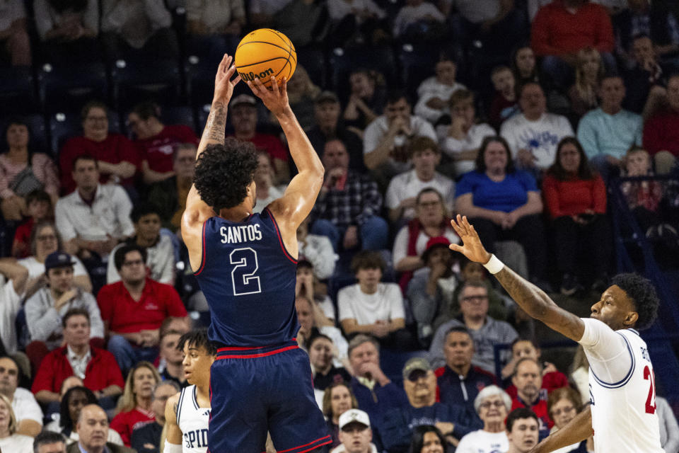 Dayton forward Nate Santos (2) shoots over Richmond forward Isaiah Bigelow (24) during the first half of an NCAA college basketball game on Saturday, Jan. 27, 2024 in Richmond, Va. (AP Photo/Shaban Athuman)