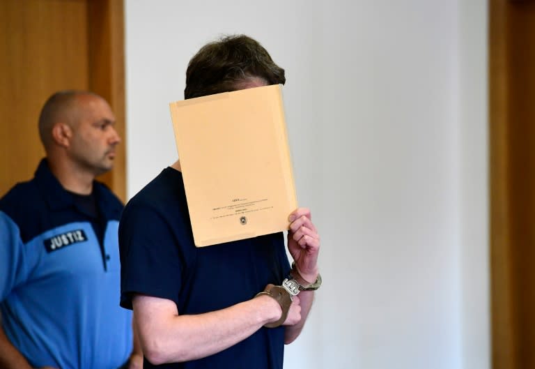 Silvio Schulz, a German security guard accused of murdering two children, one of them a four-year-old Bosnian boy snatched from a crowded migrant centre, arrives in court on July 26, 2016