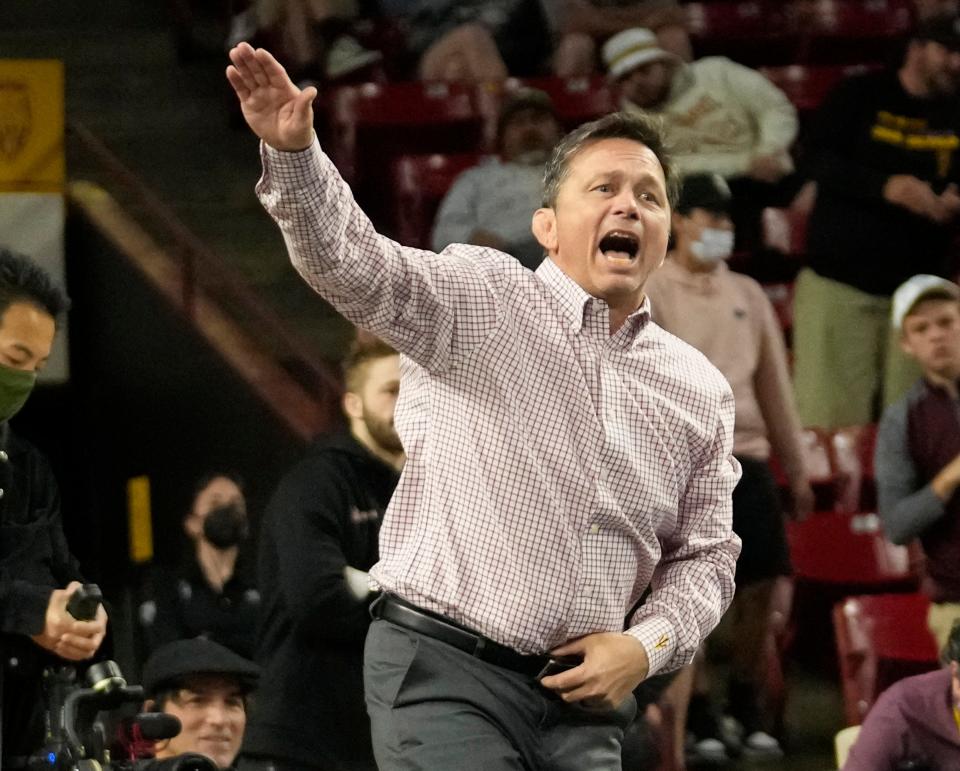 Arizona State wrestling coach Zeke Jones instructs Jacori Teemer as he wrestles Oregon State's Hunter Willits in the 157-pound weight class during the finals of the Pac-12 wrestling championships at Desert Financial Arena in Tempe on March 6, 2022.