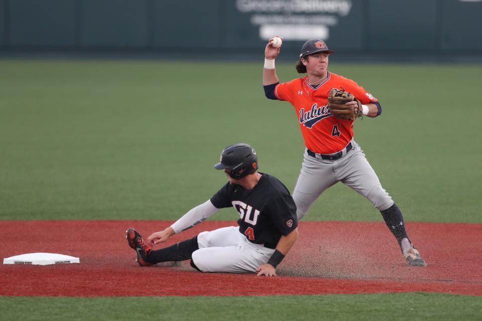 Auburn infielder Brody Moore, right, throws to first base after putting out Oregon State's Justin Boyd, left, on a fielder's choice during the first inning of an NCAA college baseball tournament super regional game on Monday, June 13, 2022, in Corvallis, Ore. (AP Photo/Amanda Loman)