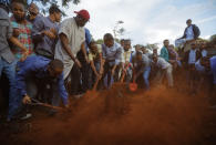 <p>Mourners bury the body of Abdalla Dahir near to the grave of his colleague Feisal Ahmed, who were both killed in Tuesday’s attack, at their funerals in Nairobi, Kenya Wednesday, Jan. 16, 2019. The two worked for the Somalia Stability Fund, managed by the London-based company Adam Smith International, and were killed in Tuesday’s assault by Islamic extremist gunmen on a luxury hotel and shopping complex. (AP Photo/Ben Curtis) </p>