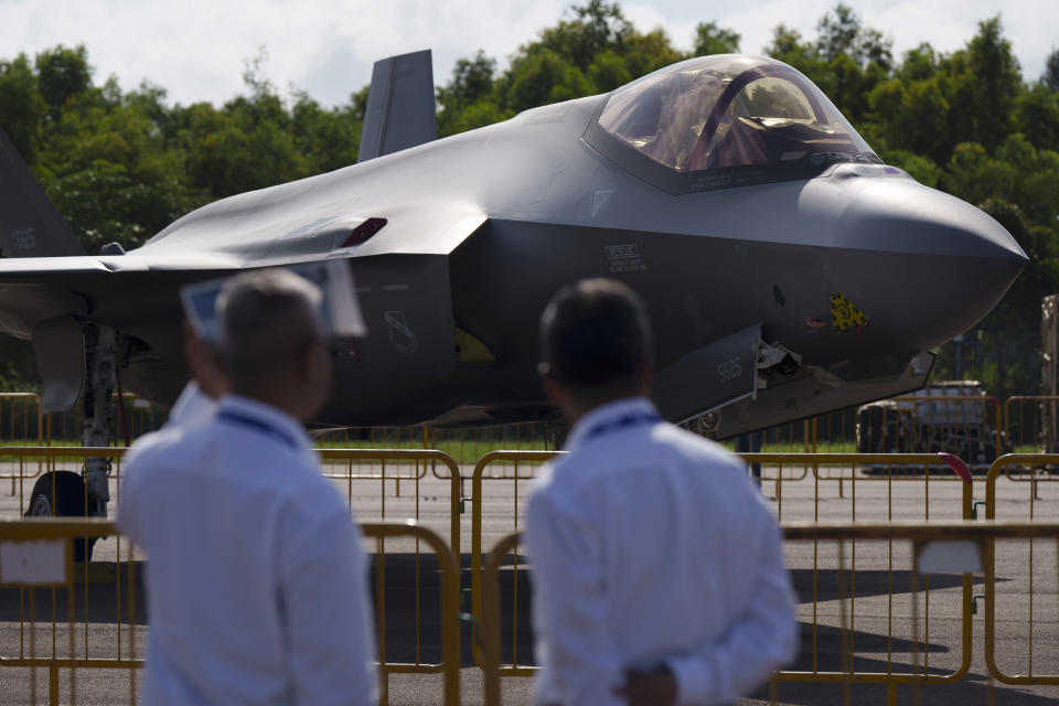 Visitors stand near an F35A aircraft on display during the first day of the Singapore Airshow in Singapore, Tuesday, Feb. 20, 2024. (AP Photo/Vincent Thian)