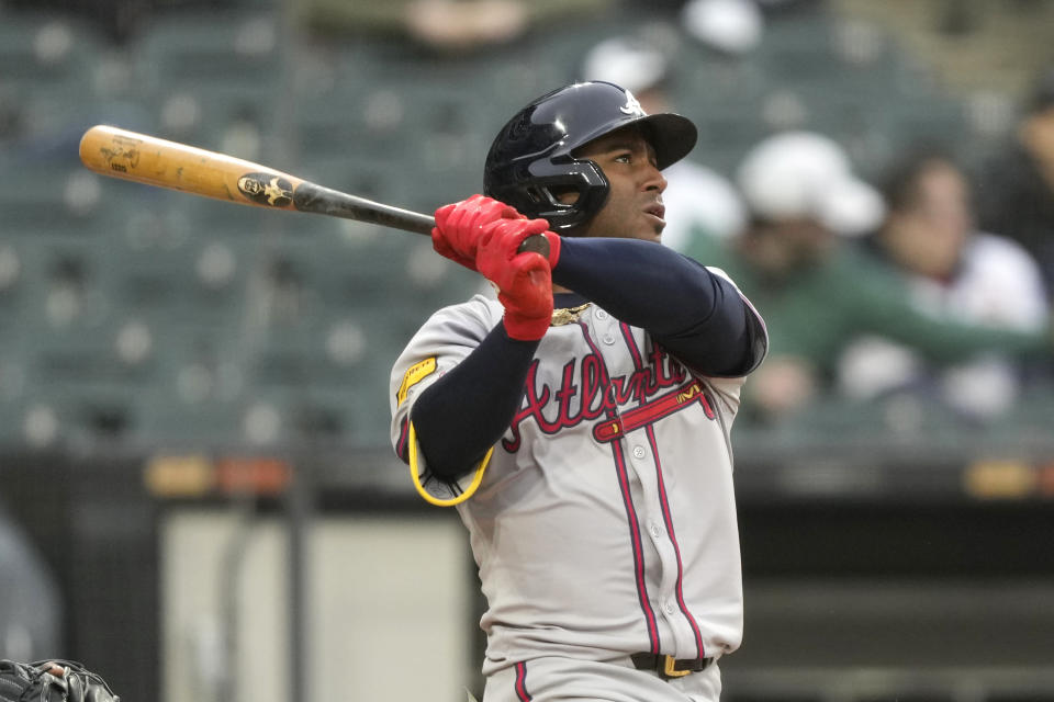 Atlanta Braves' Ozzie Albies watches his RBI double off Chicago White Sox relief pitcher Bryan Shaw during the sixth inning of a baseball game Monday, April 1, 2024, in Chicago. Ronald Acuna Jr. scored on the play. (AP Photo/Charles Rex Arbogast)