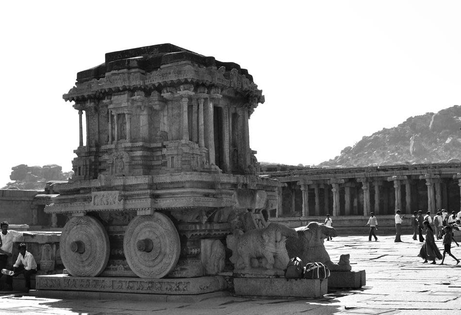 Thanks to the iconic stone chariot the Vijaya Vittala temple is the most popular spot in Hampi. This chariot is the emblem of Karnataka Tourism. From the marks on the platform, where the wheels rest, it appears that the wheels were once free to move around the axis. It has and probably will always be the flag-bearer of Hampi’s relics.<br><br><br>Photographer, traveler and wildlife enthusiast Radha Rangarajan loves to wander, camera in tow. An aesthete, her forte is creative and offbeat compositions. Radha has presented her images in many forums and publications. Faces intrigue her and she loves to tell stories through her photographs. Birds, butterflies, leaves and shafts of light fuel her imagination. Besides nature and wildlife photography, she enjoys traveling and making images of people and places. <a href="http://radha-rangarajan.blogspot.com/" rel="nofollow noopener" target="_blank" data-ylk="slk:Enjoy more of her work at her blog;elm:context_link;itc:0;sec:content-canvas" class="link ">Enjoy more of her work at her blog</a>