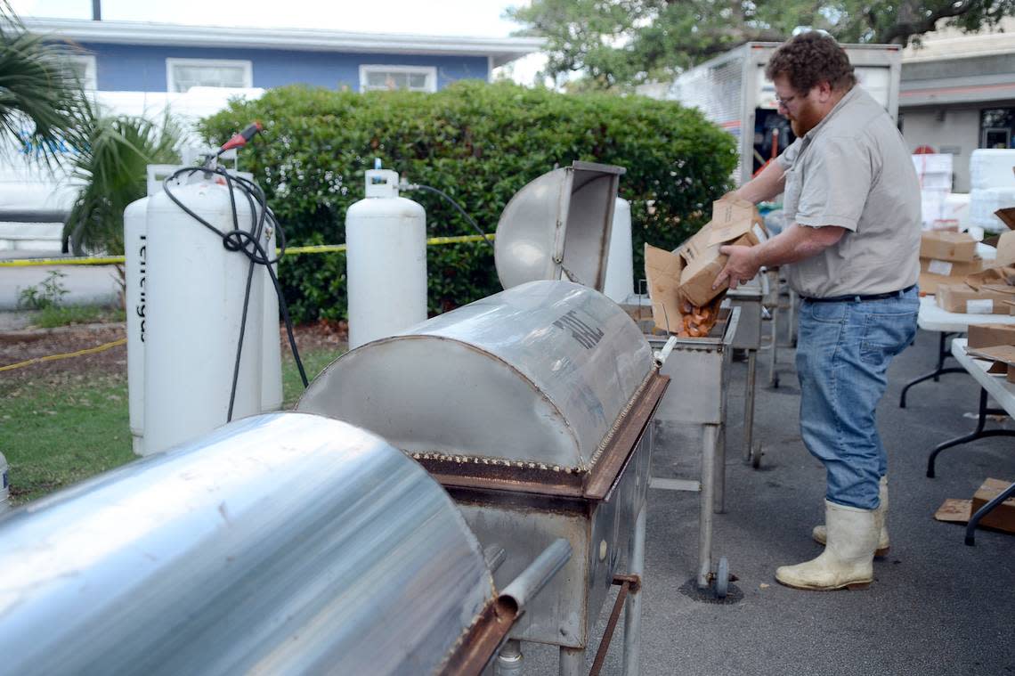 Craig Reaves, owner of Sea Eagle Market, drops sausage into the boiling water in preparation for the night’s Lowcountry Supper during the 2014 Beaufort Water Festival.