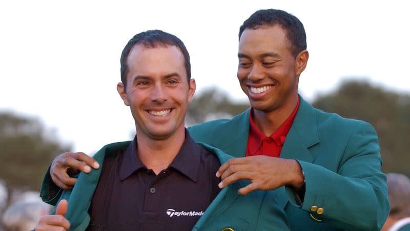 2002 champion Tiger Woods, right, helps Mike Weir don the traditional Green Jacket after the former BYU standout won the 2003 Masters, at the Augusta National Golf Club in Augusta, Ga., April 13, 2003. Weir will be back at Augusta this week competing at the Masters.