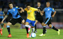 Football Soccer - Uruguay v Brazil - World Cup 2018 Qualifiers - Centenario stadium, Montevideo, Uruguay - 23/3/17 - Brazil's Neymar (10) and Uruguay's Egidio Arevalo Rios (R) and Matias Vecino in action. REUTERS/Andres Stapff