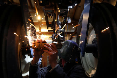 Soybean farmer Austin Rincker makes a modification to his planter as he installs a high speed planting conversion component in Moweaqua, Illinois, U.S., March 6, 2019. REUTERS/Daniel Acker/Files