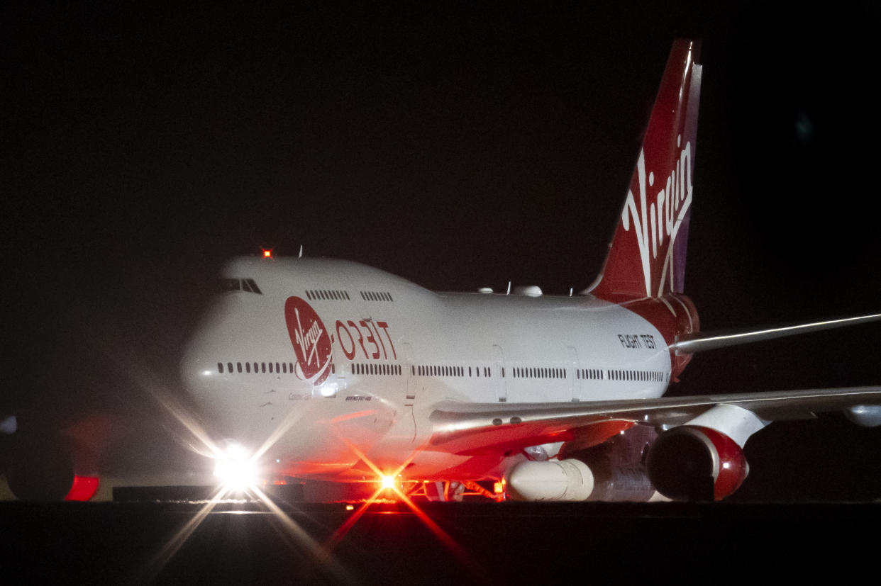 NEWQUAY, ENGLAND - JANUARY 09: A general view of Cosmic Girl, a repurposed Boeing 747 aircraft carrying the LauncherOne rocket under its left wing, as final preparations are made at Cornwall Airport Newquay on January 9, 2023 in Newquay, United Kingdom. Virgin Orbit launches its LauncherOne rocket from the spaceport in Cornwall, marking the first ever orbital launch from the UK. The mission has been named Start Me Up after the Rolling Stones hit. (Photo by Matthew Horwood/Getty Images)