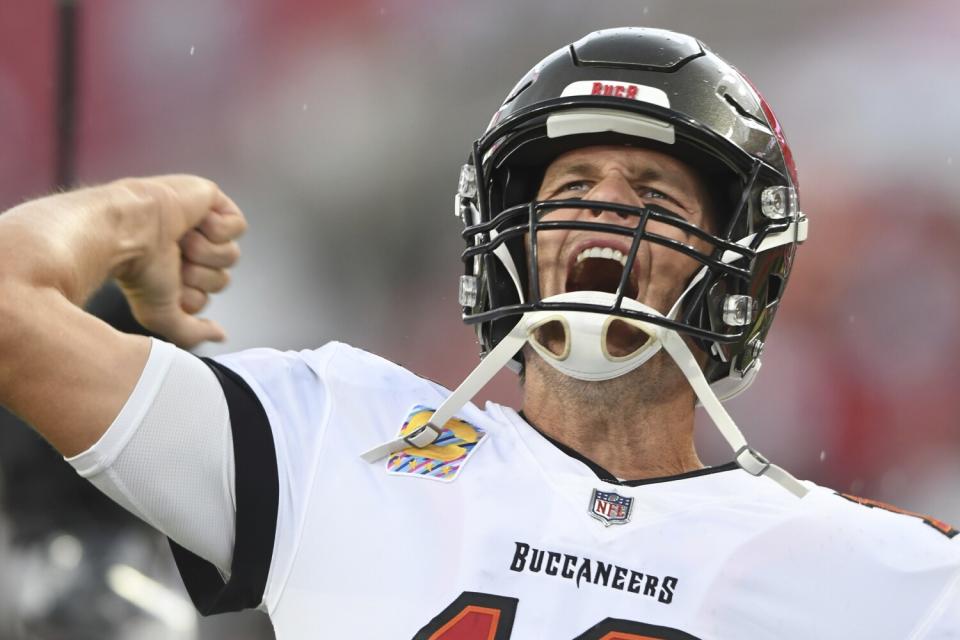 Tampa Bay Buccaneers quarterback Tom Brady (12) pumps his fist and yells as he runs onto the field