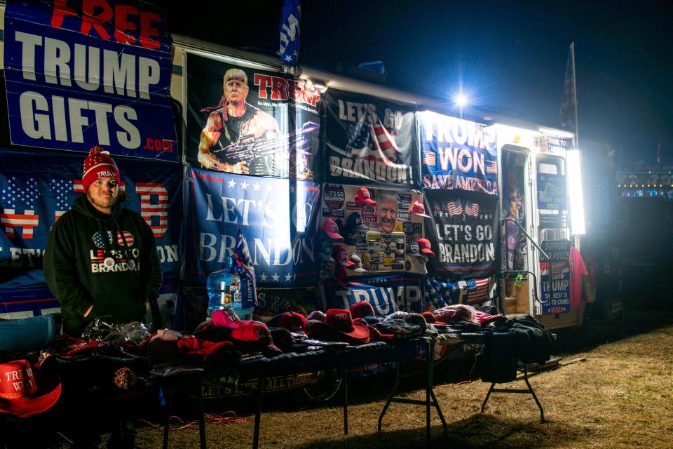 A Trump supporter sells merchandise during the 'Save America' rally at the Montgomery County Fairgrounds on January 29, 2022 in Conroe, Texas