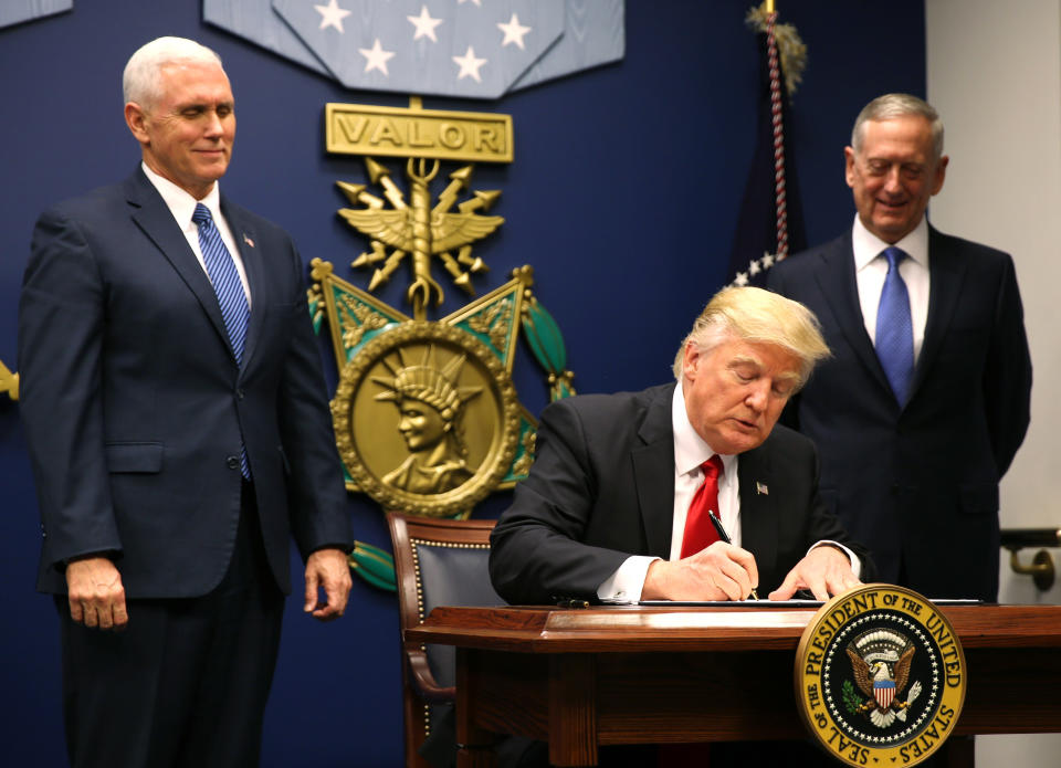 President Donald Trump signs&nbsp;the first ban, Jan. 27, 2017. It barred travel from Muslim-majority countries for 90 days, suspected the refugee resettlement program for 120 days and indefinitely banned the entry of Syrian refugees. (Photo: Carlos Barria / Reuters)