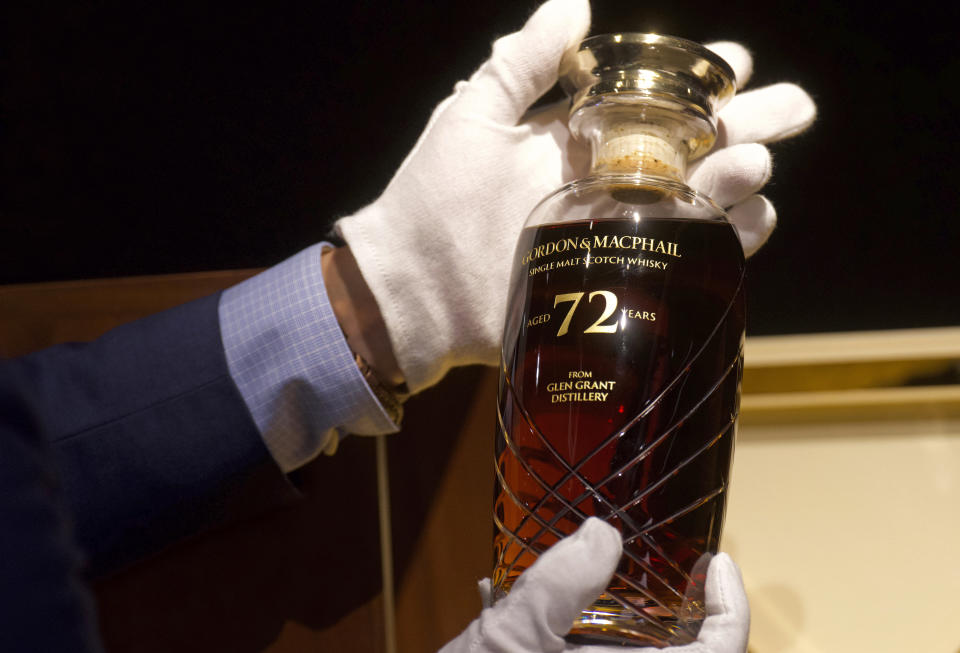 Expecting to fetch up to US$49,000 at auction, a 72-year-old bottle of Glen Grant single malt whisky from Scotland is displayed at a Bonhams auction preview in Hong Kong, Thursday, Jan. 28, 2021. Despite the economic uncertainty brought on by the pandemic, interest in the rare whisky remains high. Compared to other investment commodities, collectable whisky is doing strong in the past 10 years, with a four-fold increase in its price, Bonhams specialist Christopher Pong said. (AP Photo/Vincent Yu)