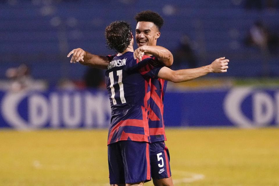 United States' Antonee Robinson, right, and his teammate Brenden Aaronson celebrate at the end of the game against Honduras during a qualifying soccer match for the FIFA World Cup Qatar 2022, in San Pedro Sula, Honduras, Wednesday, Sept. 8, 2021. United States won 4-1. (AP Photo/Moises Castillo)