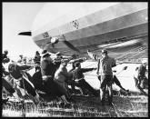 <p>Navy men and others moor the Hindenburg at the Lakehurst Naval Station. (Hulton-Deutsch Collection/Corbis via Getty Images) </p>