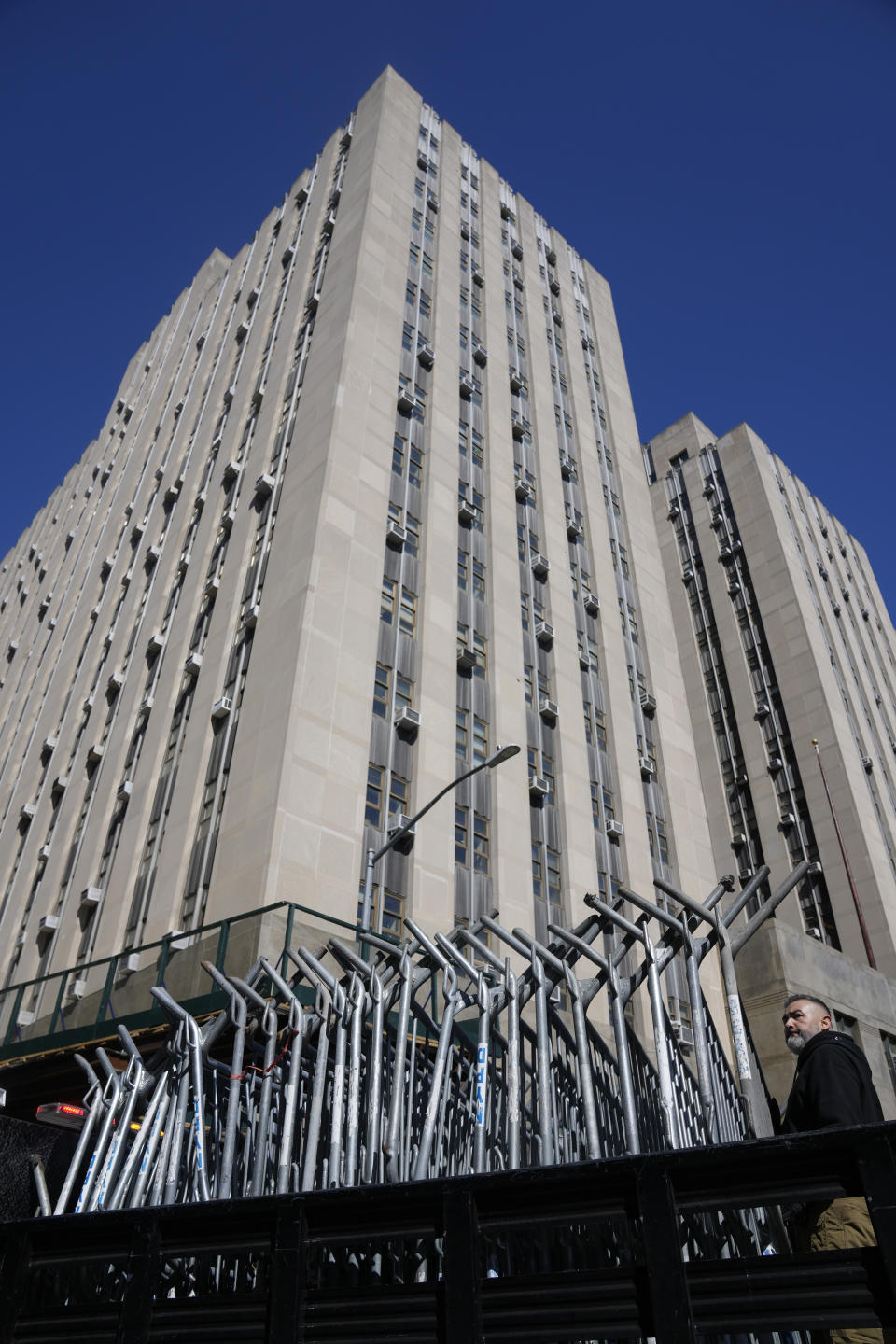 Barricades are unloaded from a truck near the courts in New York, Monday, March 20, 2023. (AP Photo/Seth Wenig)