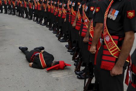 An Indian Army soldier faints during a ceremony to commemorate 50th anniversary of a war between India and Pakistan, at the India Gate war memorial, in New Delhi, India, August 28, 2015. REUTERS/Adnan Abidi