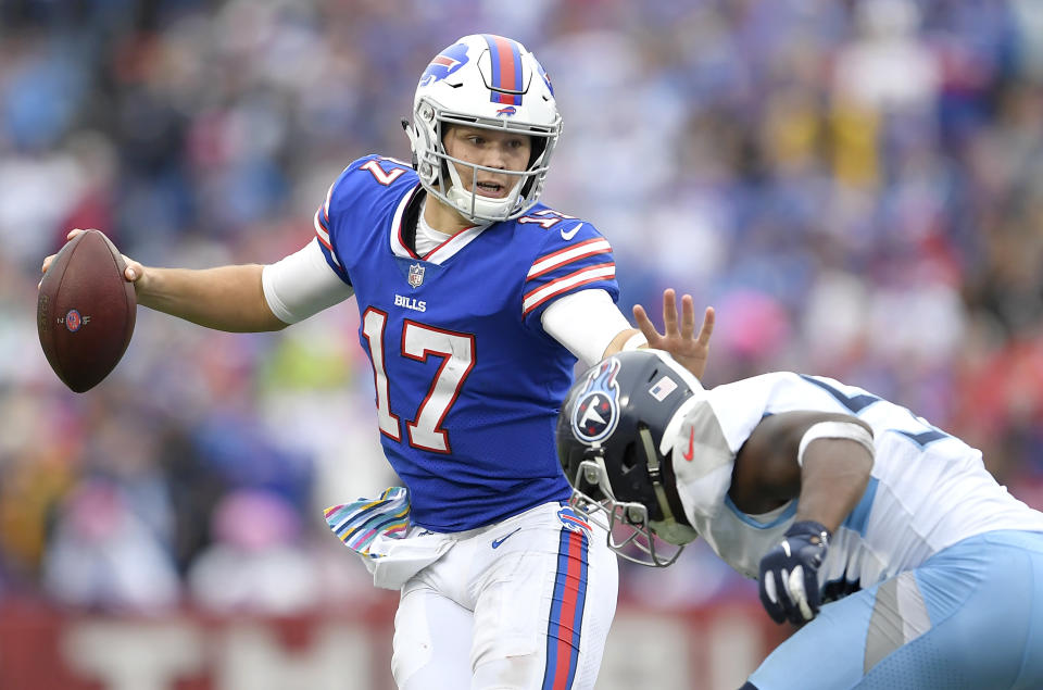 Buffalo Bills quarterback Josh Allen, left, tries to avoid a tackle from Tennessee Titans linebacker Sharif Finch during the second half of an NFL football game, Sunday, Oct. 7, 2018, in Orchard Park, N.Y. (AP Photo/Adrian Kraus)